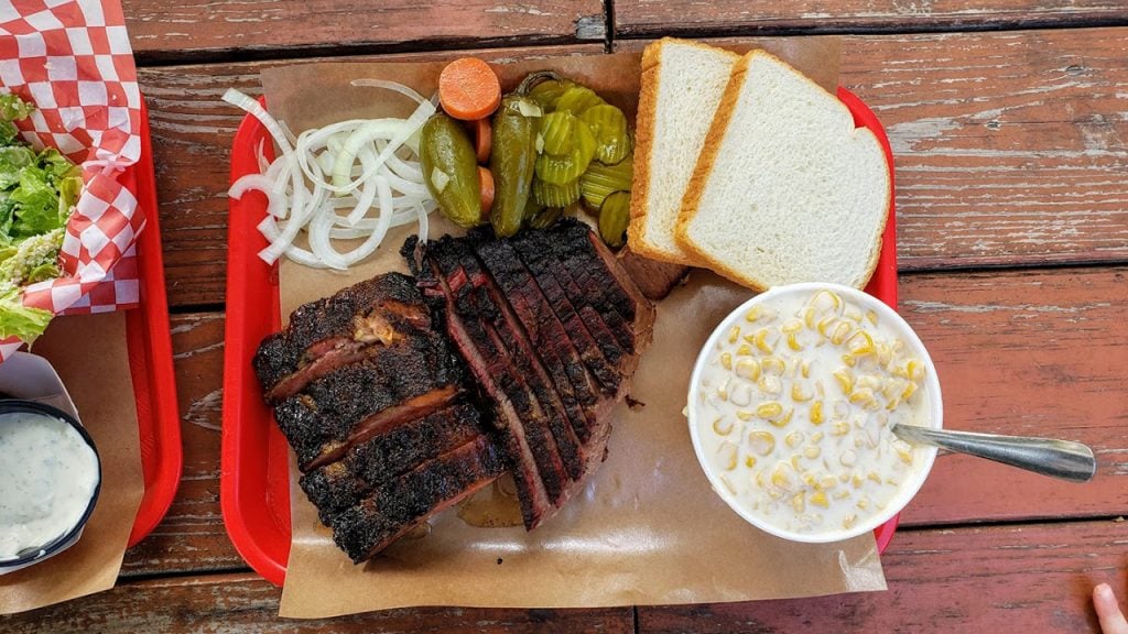 tray of bbq meat, bread and pickles