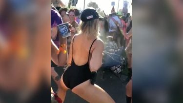 Woman dancing at a music festival in a swimsuit