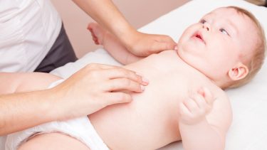 Baby being treated by a chiropractor