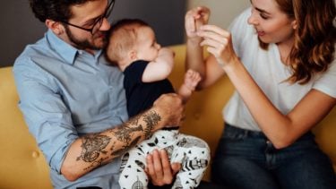 2020 baby names: A new dad and mom play with their baby