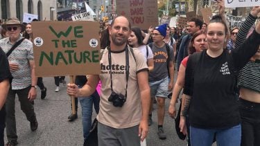 Climate change parents: Joshua Ostroff holds a sign that reads "We the nature" at a climate strike