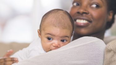 Baby names 2020: A mother hugs her newborn baby