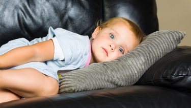 Boy lying on couch with possible transient synovitus