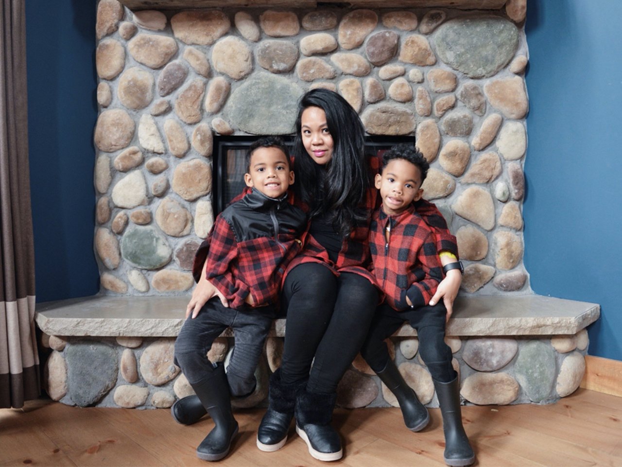 Sunshine and her boys posing on the fireplace in matching plaid