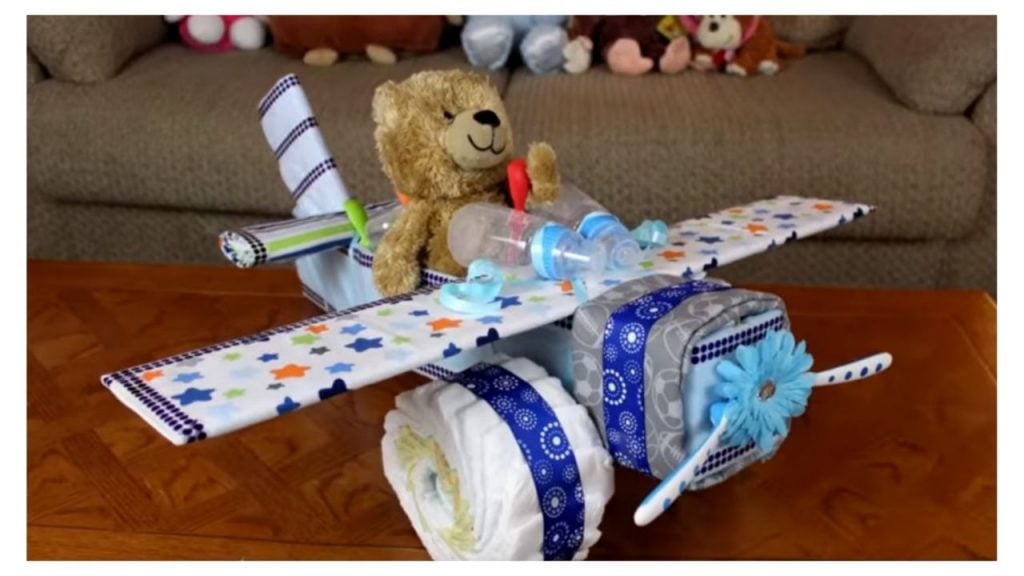 Teddy bear sits in an airplane made of diapers