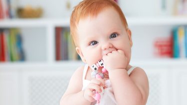 Teething rash: Infant chewing on her first