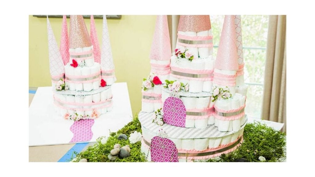 Four-layered diaper cake shaped into a pink castle