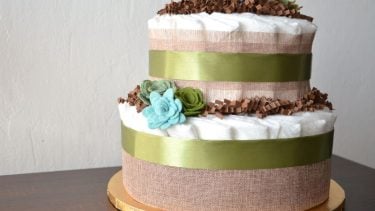 Diaper cake: Two-layered rustic cake made out of diapers and flowers