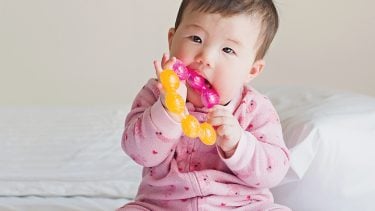 baby chewing on a teething ring