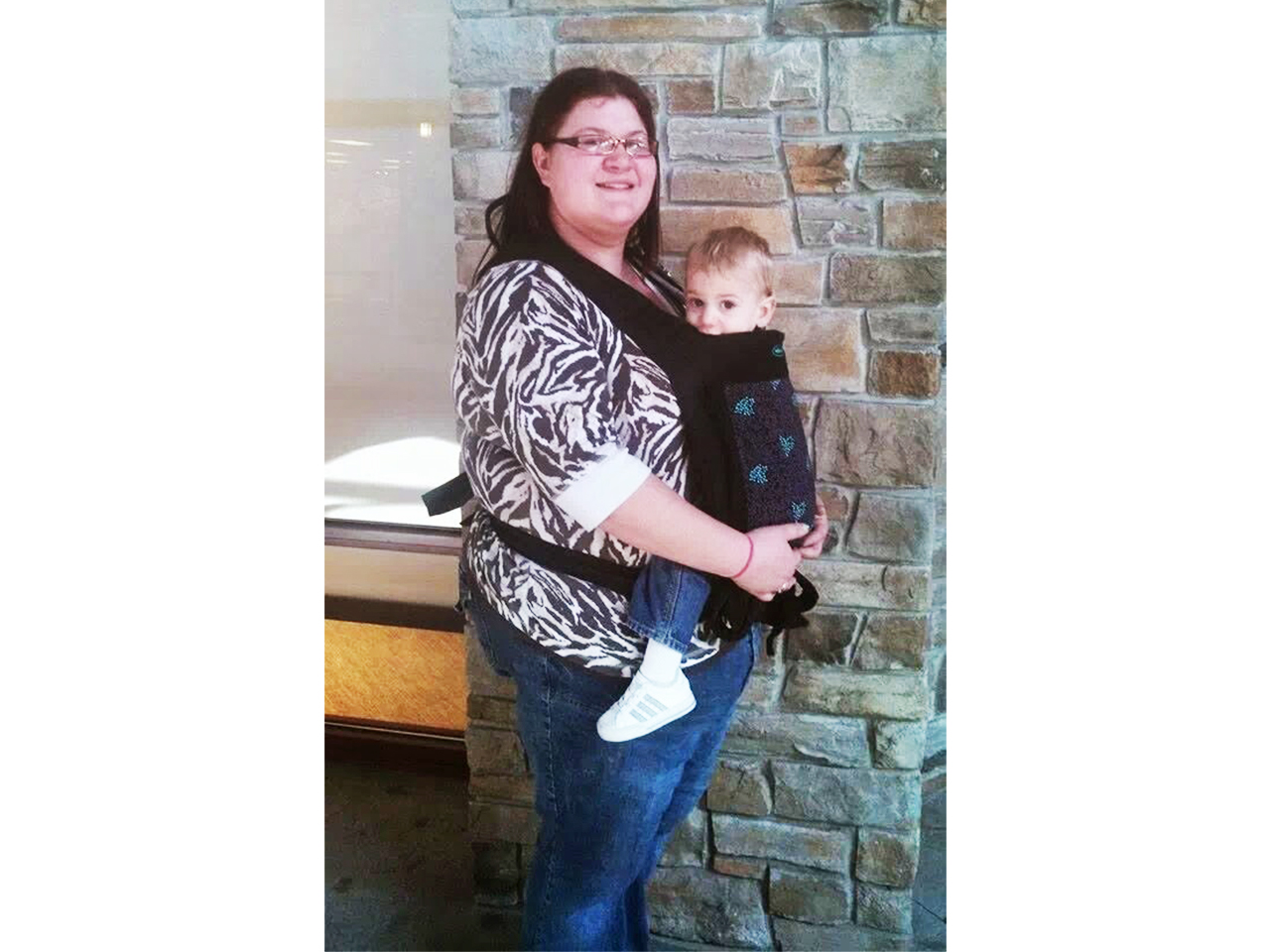 Mom carrying her baby in an Infantino baby carrier