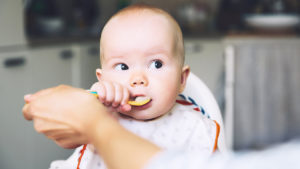Baby eating food from a spoon