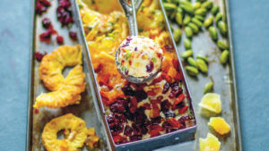 tray of dried fruit with basin filled with colourful ice cream