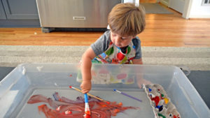 child painting as an indoor activity for kids