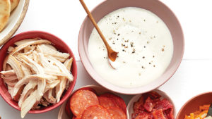 bowl of white sauce with a spoon