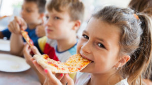 Pizza day: Kid munches on pizza