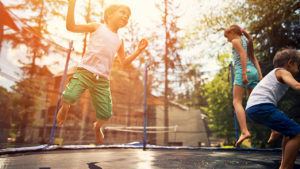 children jumping on trampoline during coronavirus outbreak