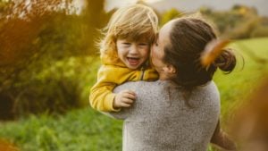 mom carrying a happy toddler infertility changed me