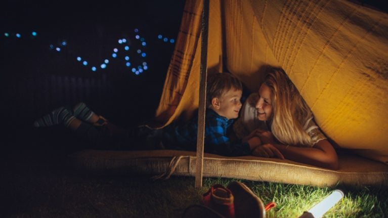mom and son camping in backyard