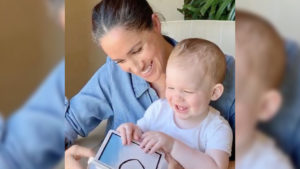 Duchess Meghan reading a board book with her son Archie on her lap