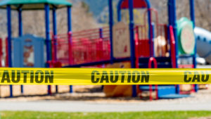 tape blocking off playground because of coronavirus pandemic