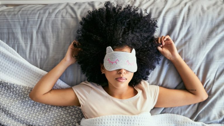 woman sleeping with cat eye mask