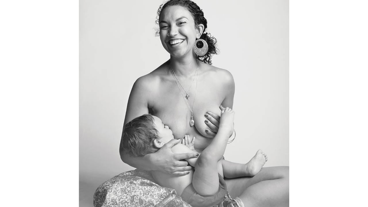 Mom smiling while breastfeeding