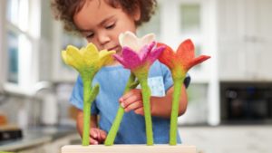 toddler playing with felt flowers