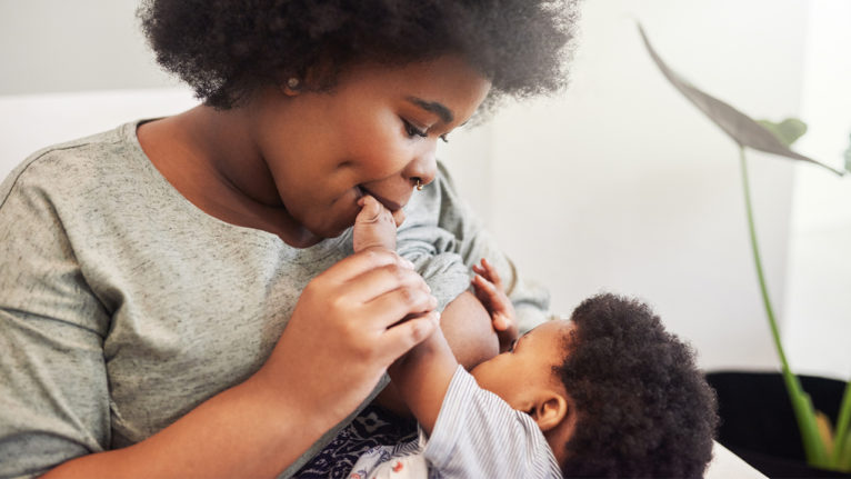 Black mother breastfeeding her baby