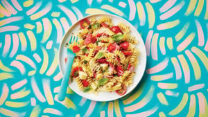 plate of big Italian pasta salad on a patterned table cloth