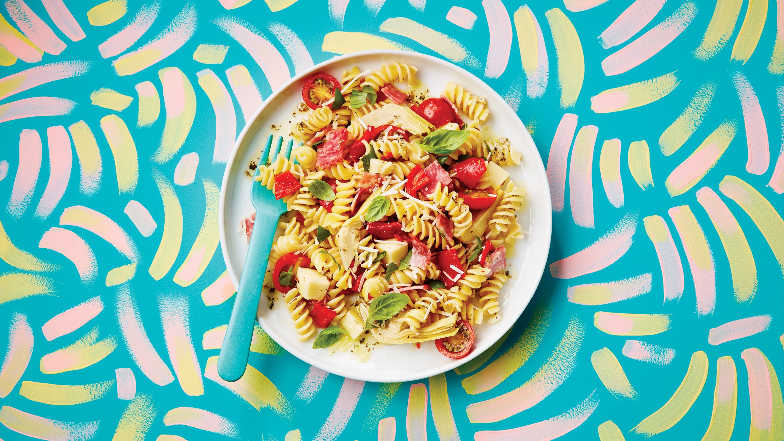 plate of big Italian pasta salad on a patterned table cloth