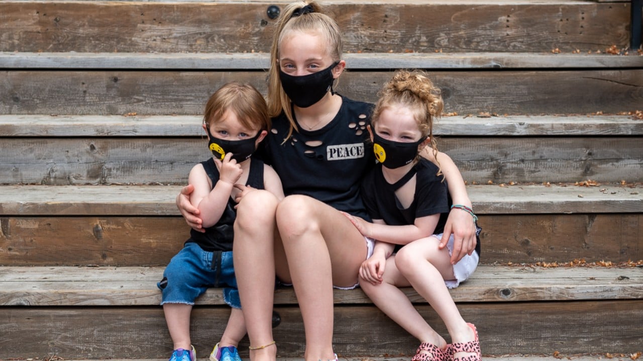 siblings wearing matching reusable cloth face masks