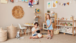 two kids playing in an organized playroom