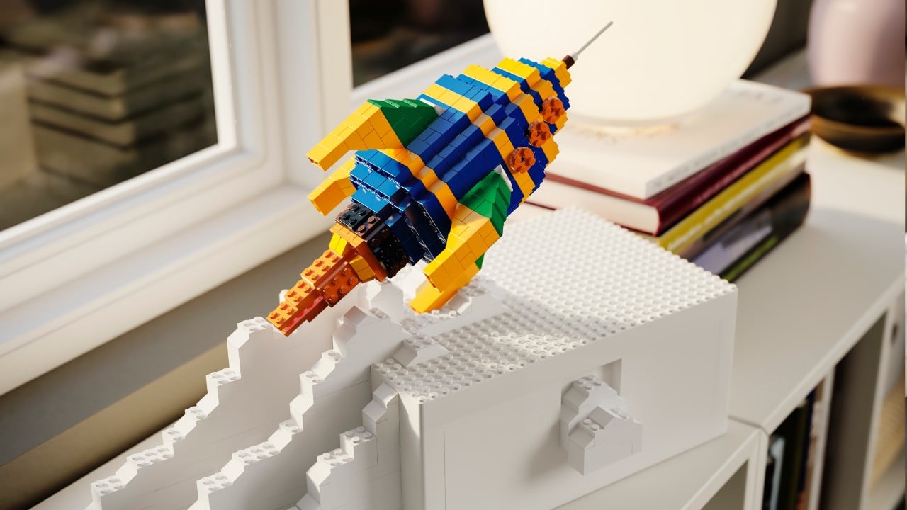 a lego set from ikea of a rocket ship taking off on a white storage box from bygglek collection