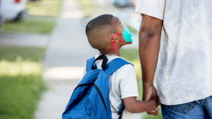 Child on his way to public school with parent