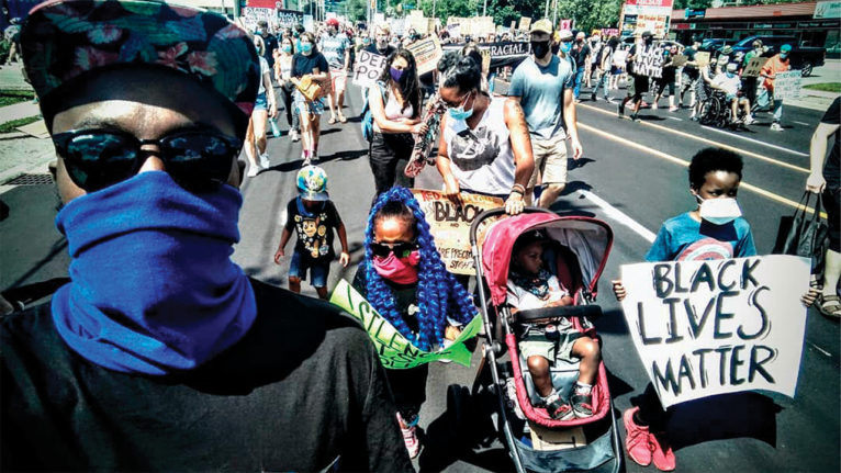Photo of a family walking in a Black Lives Matter protest.