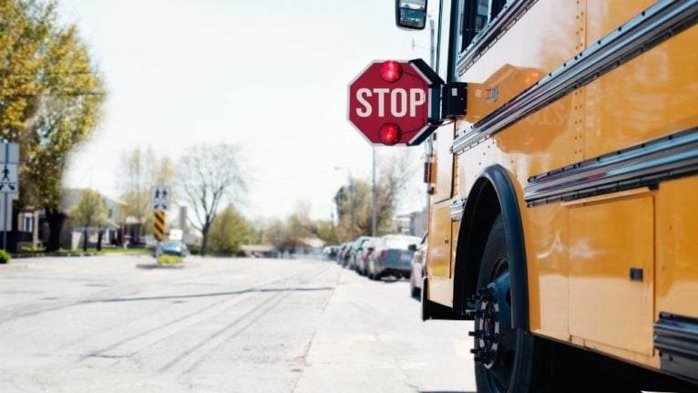 school bus parked with stop sign out