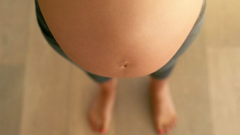 above view of pregnant belly