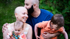 family of four with a mom who has no hair due to her cancer treatments