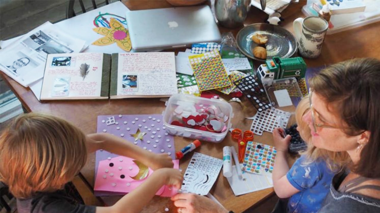 Photo of a mom and her kids crafting on the kitchen table