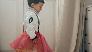 photo of a kid wearing an astronaut costume with a poofy pink tutu