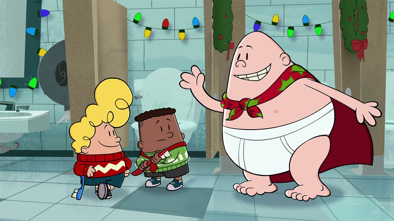 A still from Captain Underpants Mega Blissmas showing a superhero wearing underpants taking to two kids in a school bathroom