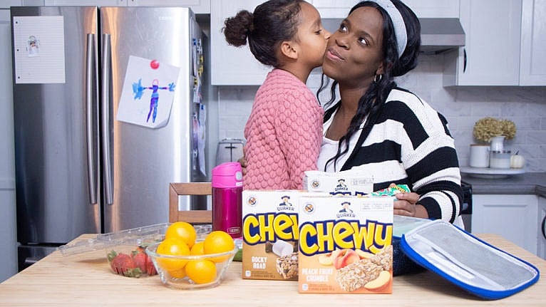 Marielle Altenor and her daughter in the kitchen with lunch snacks