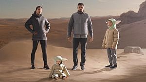 family in Star Wars themed clothing on movie set background
