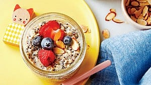 small mason jar with overnight oats topped with fruit