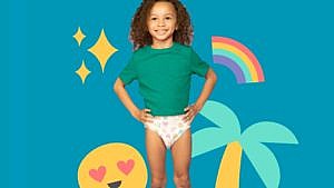 young kid wearing training diaper on coloured background