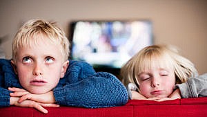 Photo of two siblings looking frustrated sitting on the couch