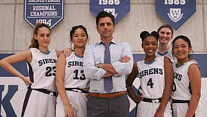 Promo image for Big Shot showing John Stamos posing with a girls basketball team