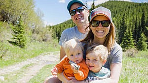 Photo of a family outside on a mountain trail