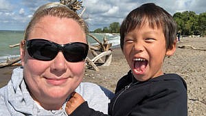 A mom and her school-aged son on the beach