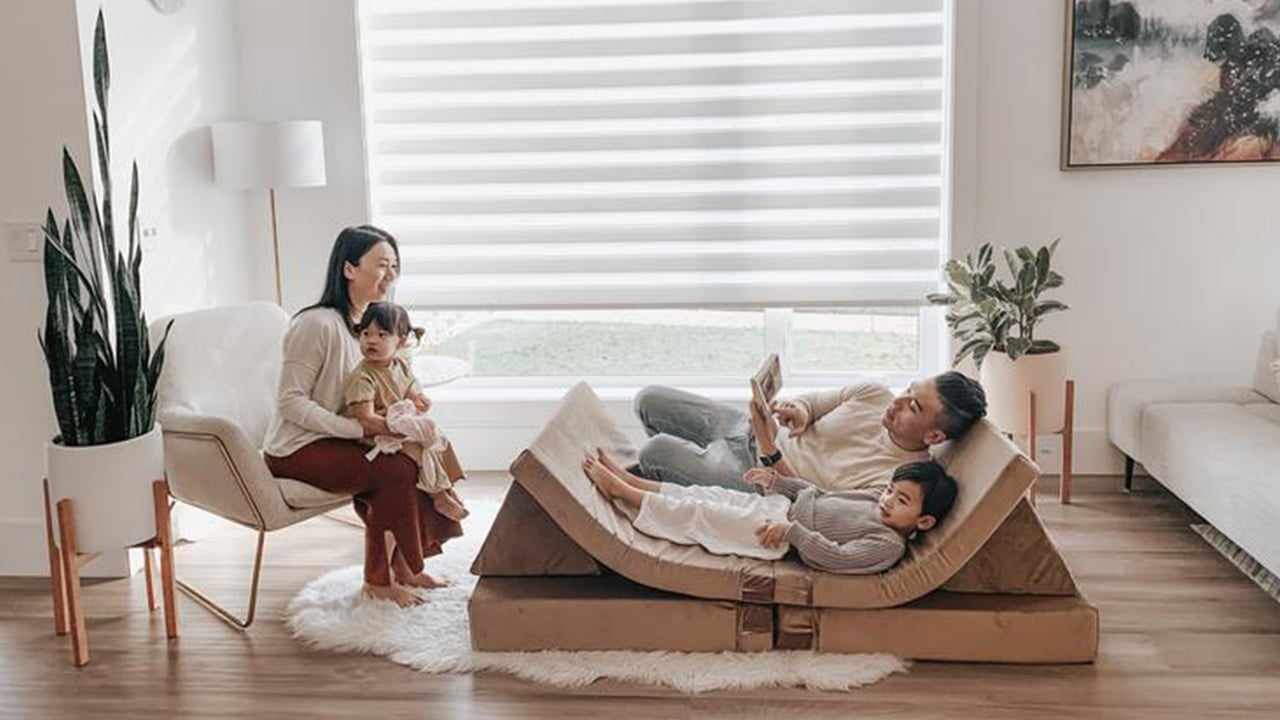 Photo of a family lounging and reading books on a modular play couch
